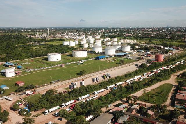 Aerial view of the Guillermo Elder Bell refinery of Bolivian state-owned oil company YPFB in Santa Cruz, Bolivia, on December 5, 2025. On Tuesday, Bolivia's new centre-right government denounced the misappropriation of millions of dollars worth of fuel under previous administrations of the Movement Towards Socialism (MAS) party, which even impacted the country during the recent fuel shortage crisis. This week, the public prosecutor's office raided the state oil company YPFB and the National Hydrocarbons Agency, which are under investigation for alleged corruption. (Photo by Rodrigo URZAGASTI / AFP)