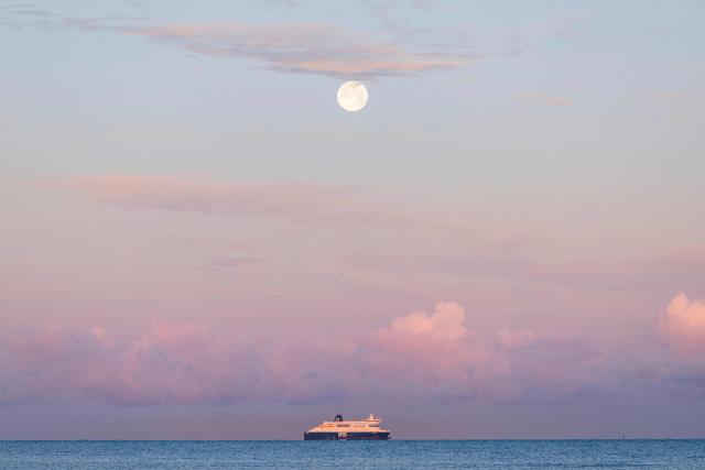A Danish international shipping and logistics company DFDS ferry sails off the beach of Gravelines, northern France, on December 5, 2025. (Photo by Sameer Al-DOUMY / AFP)