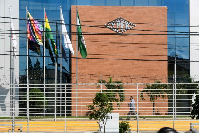 A man walks at the Guillermo Elder Bell refinery headqaurters of Bolivian state-owned oil company YPFB in Santa Cruz, Bolivia, on December 5, 2025. On Tuesday, Bolivia's new centre-right government denounced the misappropriation of millions of dollars worth of fuel under previous administrations of the MOvimiento Al Socialismo (MAS) party, which even impacted the country during the recent fuel shortage crisis. This week, the public prosecutor's office raided the state oil company YPFB and the National Hydrocarbons Agency, which are under investigation for alleged corruption. (Photo by Rodrigo URZAGASTI / AFP)