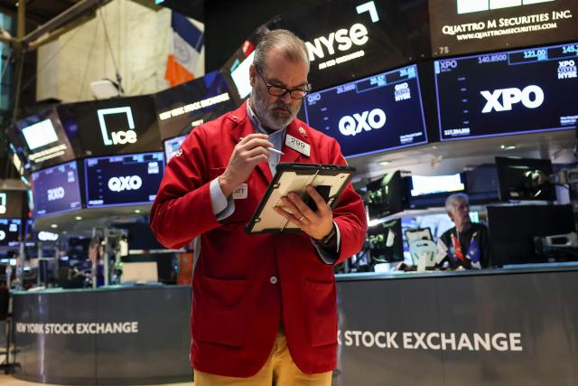 A trader works on the floor of the New York Stock Exchange (NYSE) on December 5, 2025 in New York City. Wall Street stocks advanced early Friday ahead of US inflation data, while Netflix dipped after announcing a deal to acquire Warner Bros. Discovery for $83 billion. (Photo by ANGELA WEISS / AFP)