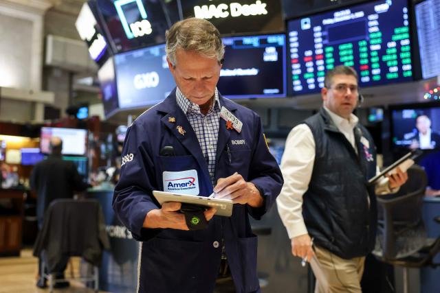 A trader works on the floor of the New York Stock Exchange (NYSE) after the opening bell in New York on December 5, 2025.  (Photo by ANGELA WEISS / AFP)