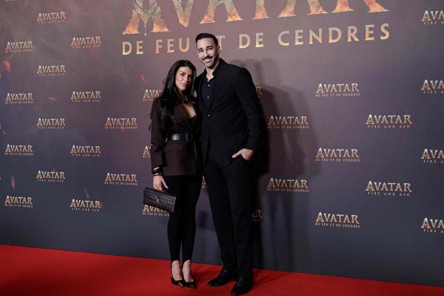 Brazilian content creator Louana Franco Silva and French former football player Adil Rami pose during a photocall for the European premiere of "Avatar: Fire and Ash" at the Seine Musicale concert hall in Boulogne-Billancourt, on the outskirts of Paris on December 5, 2025. (Photo by STEPHANE DE SAKUTIN / AFP)