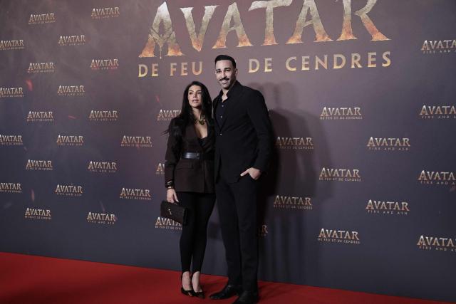 Brazilian content creator Louana Franco Silva and French former football player Adil Rami pose during a photocall for the European premiere of "Avatar: Fire and Ash" at the Seine Musicale concert hall in Boulogne-Billancourt, on the outskirts of Paris on December 5, 2025. (Photo by STEPHANE DE SAKUTIN / AFP)