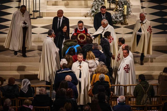 Faithfuls pray at the Holy Crown of Thorns during the veneration of the Holy Crown of Thorns at cathedral of Notre-Dame of Paris, in Paris on December 5, 2025. (Photo by Dimitar DILKOFF / AFP)