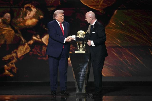 (L-R) US President Donald Trump shakes hands with FIFA President Gianni Infantino as he receives the FIFA Peace Prize during the draw for the 2026 FIFA Football World Cup taking place in the US, Canada and Mexico, at the Kennedy Center, in Washington, DC, on December 5, 2025. (Photo by Brendan SMIALOWSKI / AFP)