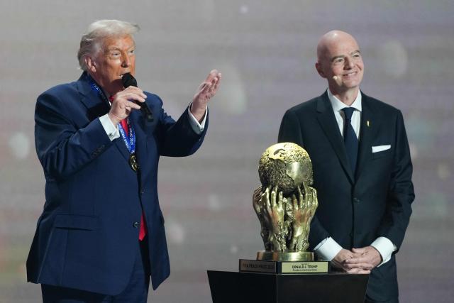(L/R) US President Donald Trump speaks as he receives the FIFA Peace Prize alongside FIFA President Gianni Infantino during the draw for the 2026 FIFA Football World Cup taking place in the US, Canada and Mexico, at the Kennedy Center, in Washington, DC, on December 5, 2025. (Photo by Stephanie Scarbrough / POOL / AFP)