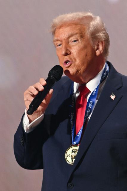 US President Donald Trump speaks as he receives the FIFA Peace Prize during the draw for the 2026 FIFA Football World Cup taking place in the US, Canada and Mexico, at the Kennedy Center, in Washington, DC, on December 5, 2025. (Photo by Mandel NGAN / POOL / AFP)