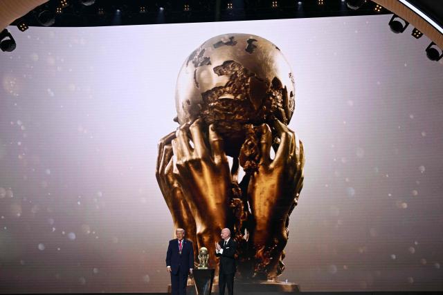 (L/R) US President Donald Trump looks on as he receives the FIFA Peace Prize from FIFA President Gianni Infantino during the draw for the 2026 FIFA Football World Cup taking place in the US, Canada and Mexico, at the Kennedy Center, in Washington, DC, on December 5, 2025. (Photo by Brendan SMIALOWSKI / AFP)