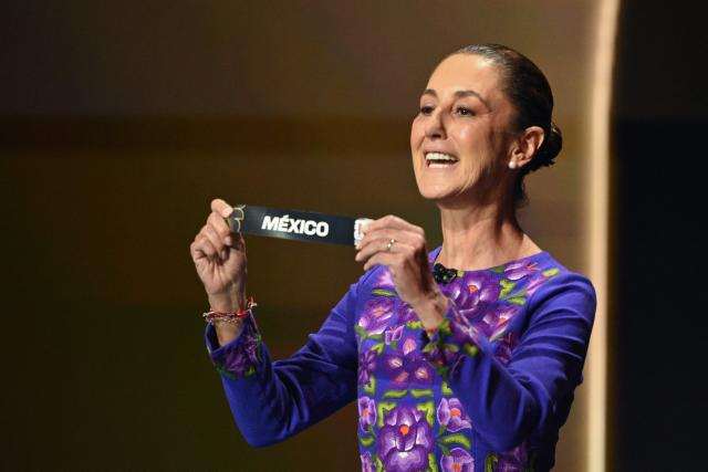 Mexico's President Claudia Sheinbaum shows the card reading Mexico during the draw for the 2026 FIFA Football World Cup taking place in the US, Canada and Mexico, at the Kennedy Center, in Washington, DC, on December 5, 2025. (Photo by Mandel NGAN / POOL / AFP)