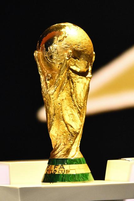 The World Cup Trophy sits on the podium on stage during the draw for the 2026 FIFA Football World Cup taking place in the US, Canada and Mexico, at the Kennedy Center, in Washington, DC, on December 5, 2025. (Photo by Mandel NGAN / POOL / AFP)