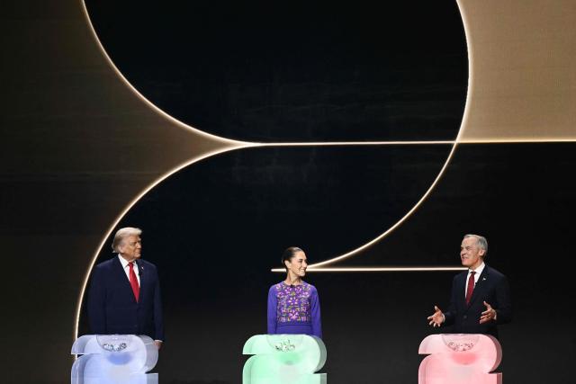 (L-R) US President Donald Trump, Mexico's President Claudia Sheinbaum, and Canada's Prime Minister Mark Carney stand on stage during the draw for the 2026 FIFA Football World Cup taking place in the US, Canada and Mexico, at the Kennedy Center, in Washington, DC, on December 5, 2025. (Photo by Brendan SMIALOWSKI / AFP)