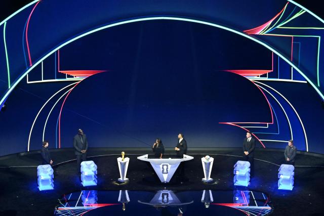 US Draw assistant Shaquille O’Neal (2-L) stands on stage during the draw for the 2026 FIFA Football World Cup taking place in the US, Canada and Mexico, at the Kennedy Center, in Washington, DC, on December 5, 2025. (Photo by Roberto SCHMIDT / AFP)