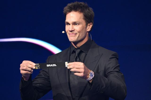 US Draw assistant Tom Brady shows the card reading Brazil during the draw for the 2026 FIFA Football World Cup taking place in the US, Canada and Mexico, at the Kennedy Center, in Washington, DC, on December 5, 2025. (Photo by Mandel NGAN / POOL / AFP)