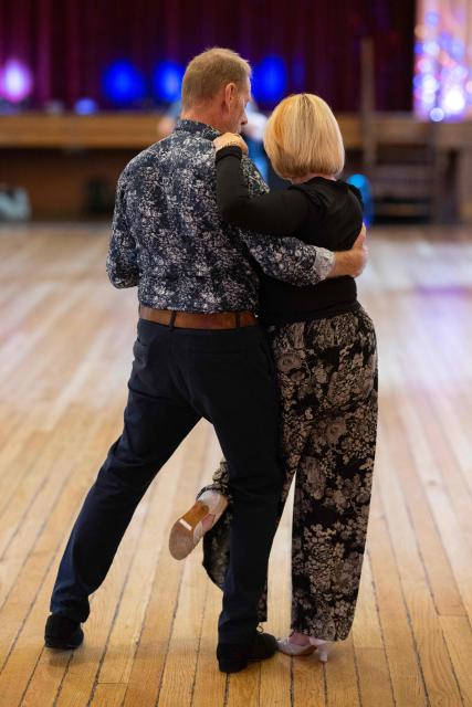 Ballroom dancers take part in an afternoon Tea Dance in the Riley-Smith Hall, in Tadcaster, northern England on October 15, 2025. Tea dances, which evolved from the tradition of afternoon tea in the late 19th century, are enjoying a revival, especially since the pandemic. Often cited as an effective way to combat loneliness, the dances are also attributed to improving the participants' mental and physical health. Frequently hosted in Victorian and Edwardian-era halls, tea dances typically offer a mixture of ballroom and sequence dancing styles and feature refreshments of tea, coffee and cakes. (Photo by Oli SCARFF / AFP)