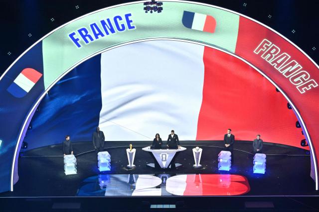 France's flag is displayed on a scren during the draw for the 2026 FIFA Football World Cup taking place in the US, Canada and Mexico, at the Kennedy Center, in Washington, DC, on December 5, 2025. (Photo by Roberto SCHMIDT / AFP)