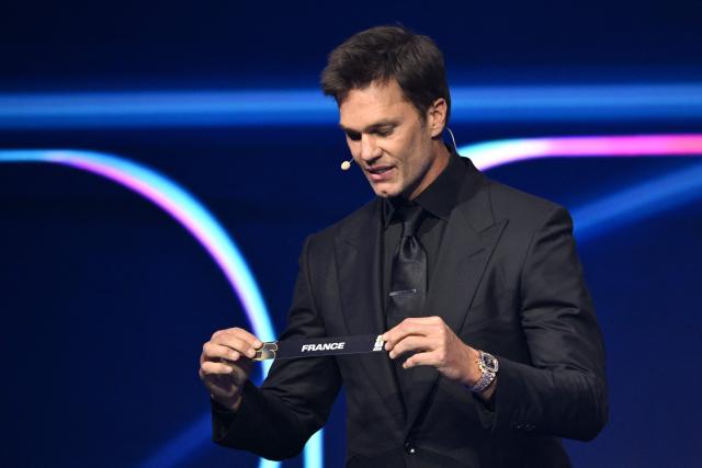 US Draw assistant Tom Brady shows the card reading France during the draw for the 2026 FIFA Football World Cup taking place in the US, Canada and Mexico, at the Kennedy Center, in Washington, DC, on December 5, 2025. (Photo by Mandel NGAN / POOL / AFP)