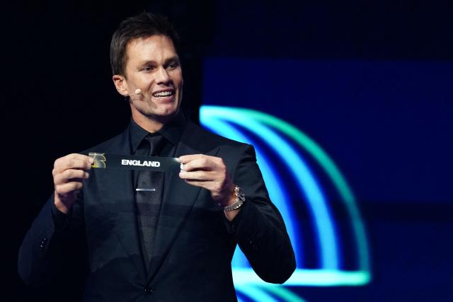 US Draw assistant Tom Brady shows the card reading France during the draw for the 2026 FIFA Football World Cup taking place in the US, Canada and Mexico, at the Kennedy Center, in Washington, DC, on December 5, 2025. (Photo by Jia Haocheng / POOL / AFP)