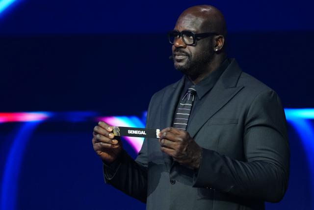 US Former Basketball player Shaquille O’Neal shows the card reading Senegal during the draw for the 2026 FIFA Football World Cup taking place in the US, Canada and Mexico, at the Kennedy Center, in Washington, DC, on December 5, 2025. (Photo by Jia Haocheng / POOL / AFP)