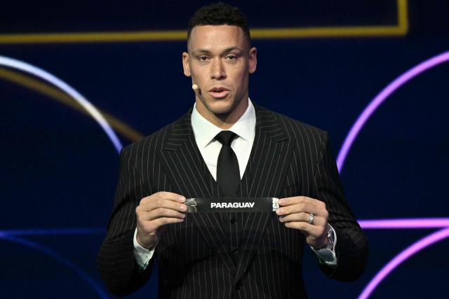 US baseball player Aaron Judge shows the card reading Paraguay during the draw for the 2026 FIFA Football World Cup taking place in the US, Canada and Mexico, at the Kennedy Center, in Washington, DC, on December 5, 2025. (Photo by Jim WATSON / AFP)