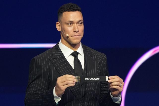 US Draw assistant Aaron Judge shows the card reading Paraguay during the draw for the 2026 FIFA Football World Cup taking place in the US, Canada and Mexico, at the Kennedy Center, in Washington, DC, on December 5, 2025. (Photo by Stephanie Scarbrough / POOL / AFP)