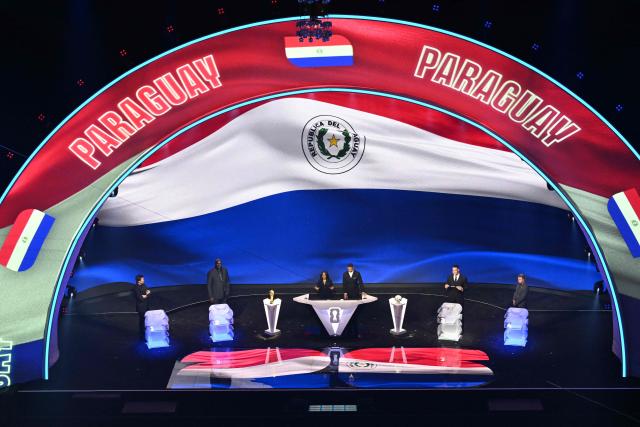 Paraguay's flag is displayed on a screen during the draw for the 2026 FIFA Football World Cup taking place in the US, Canada and Mexico, at the Kennedy Center, in Washington, DC, on December 5, 2025. (Photo by Roberto SCHMIDT / AFP)
