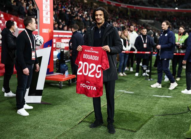 Lille's French midfielder #32 Ayyoub Bouaddi poses for a photograph with a jersey reading "Bouaddi 2029" after his contract's extension with Lille ahead of the French L1 football match between Lille LOSC and Olympique de Marseille (OM) at the Pierre-Mauroy stadium in Villeneuve-d'Ascq, northern France, on December 5, 2025. (Photo by Sameer Al-Doumy / AFP)