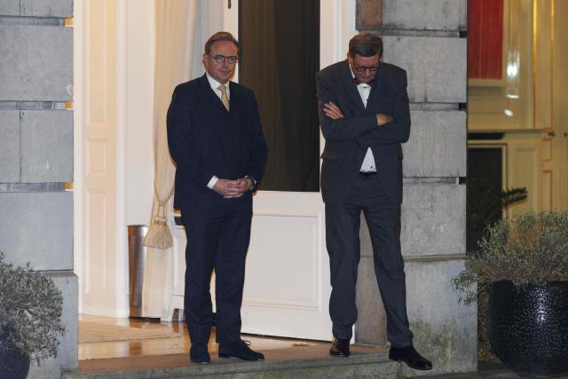 Belgium's Prime Minister Bart De Wever (L) reacts ahead of a meeting with European Commission President and Germany's Chancellor in Brussels on December 5, 2025. German Chancellor traveled to Brussels on December 5 to try to overcome Belgian opposition to using frozen Russian assets held in Belgium to fund Ukraine in its fight against Russia, Berlin said. (Photo by NICOLAS MAETERLINCK / Belga / AFP) / Belgium OUT