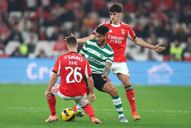 Sporting Lisbon's Colombian forward #97 Luis Suarez fights for the ball with SL Benfica's Swedish defender #26 Samuel Dahl and SL Benfica's Portuguese defender #04 Antonio Silva (back) during the Portuguese League football match between SL Benfica and Sporting CP at Estadio da Luz in Lisbon on December 5, 2025. (Photo by PATRICIA DE MELO MOREIRA / AFP)