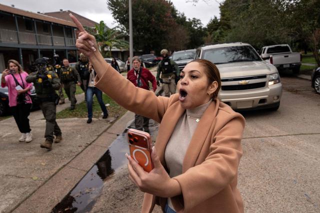 A woman shouts in reaction to a US Customs and Border Patrol immigration raid in Kenner, Louisiana, on December 5, 2025. The US Department of Homeland Security announced on December 3 it has launched a federal immigration enforcement operation, named "Operation Catahoula Crunch," in the New Orleans, Louisiana, area. (Photo by Adam GRAY / AFP)