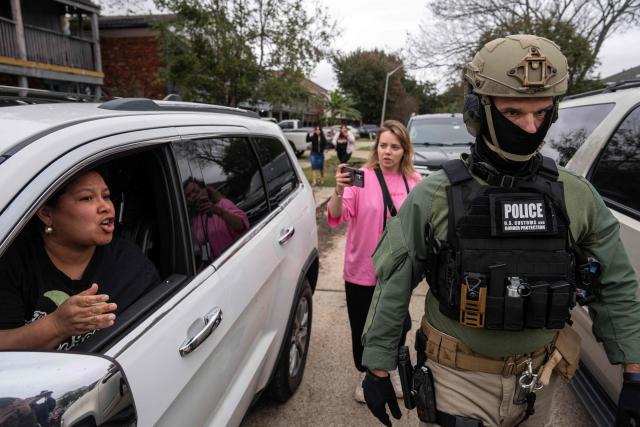 A woman reacts from her vehicle as US Customs and Border Patrol agents conduct an immigration raid in Kenner, Louisiana, on December 5, 2025. The US Department of Homeland Security announced on December 3 it has launched a federal immigration enforcement operation, named "Operation Catahoula Crunch," in the New Orleans, Louisiana, area. (Photo by Adam GRAY / AFP)