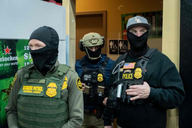 US Customs and Border Patrol agents stop at the convenience store of a gas station while participating in an immigration raid in Kenner, Louisiana, on December 5, 2025. The US Department of Homeland Security announced on December 3 it has launched a federal immigration enforcement operation, named "Operation Catahoula Crunch," in the New Orleans, Louisiana, area. (Photo by Adam GRAY / AFP)