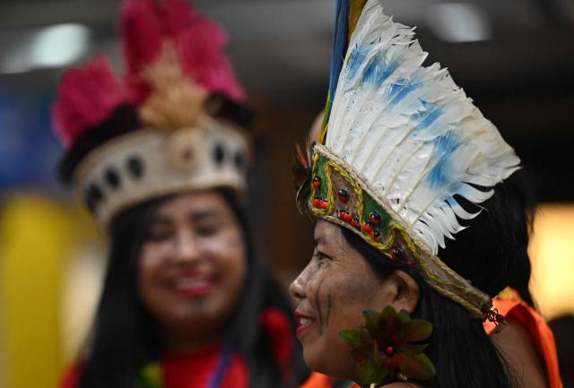 Indigenous people attend Expoartesanias Fair, which highlights artisans work and their ancestral creations in Bogota on December 5, 2025. (Photo by Raul ARBOLEDA / AFP)