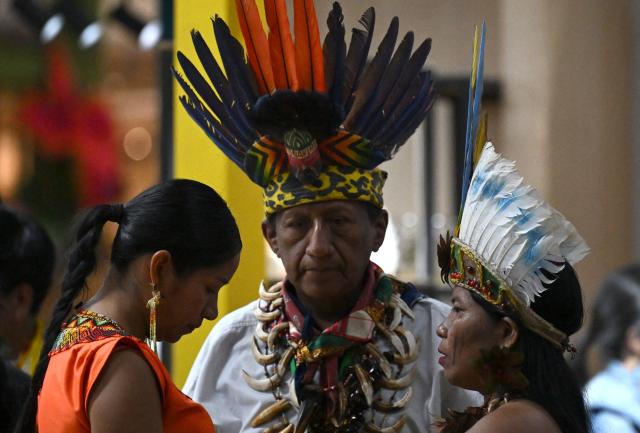Indigenous people attend Expoartesanias Fair, which highlights artisans work and their ancestral creations in Bogota on December 5, 2025. (Photo by Raul ARBOLEDA / AFP)