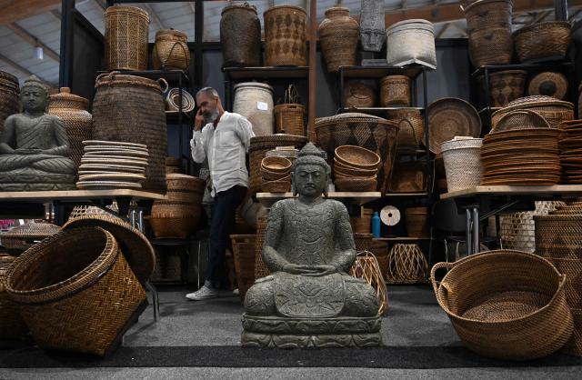 A man attends Expoartesanias Fair, which highlights artisans work and their ancestral creations in Bogota on December 5, 2025. (Photo by Raul ARBOLEDA / AFP)