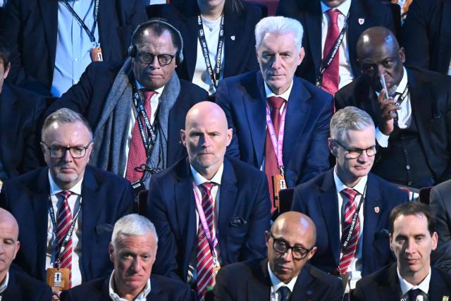 Norway's head coach Stale Solbakken (C), South Africa's head coach Hugo Broos (Top Center) France's coach Didier Deschamps (bottom left) attend the draw for the 2026 FIFA Football World Cup taking place in the US, Canada and Mexico, at the Kennedy Center, in Washington, DC, on December 5, 2025. (Photo by Pedro UGARTE / AFP)