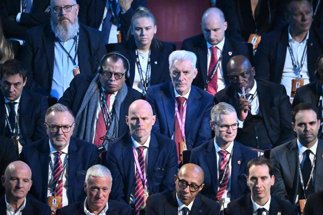 Norway's head coach Stale Solbakken(3rd row, 2nd L), South Africa's head coach Hugo Broos (2nd row, 3rd L) France's coach Didier Deschamps (bottom, 2nd L) attend the draw for the 2026 FIFA Football World Cup taking place in the US, Canada and Mexico, at the Kennedy Center, in Washington, DC, on December 5, 2025. (Photo by Pedro UGARTE / AFP)