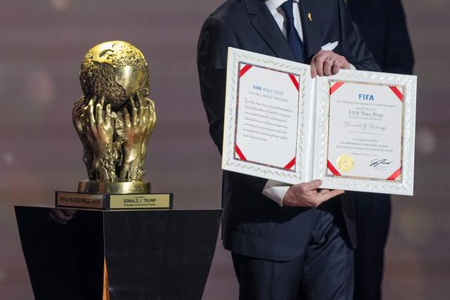 FIFA President Gianni Infantino presents President Donald Trump with the FIFA Peace Prize during the draw for the 2026 FIFA Football World Cup taking place in the US, Canada and Mexico, at the Kennedy Center, in Washington, DC, on December 5, 2025. (Photo by Stephanie Scarbrough / POOL / AFP)