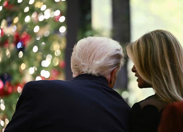 US President Donald Trump speaks with his wife First Lady Melania Trump as they attend a concert by Andrea Bocelli in the East Room of the WHite House in Washington, DC on December 5, 2025. (Photo by Brendan SMIALOWSKI / AFP)
