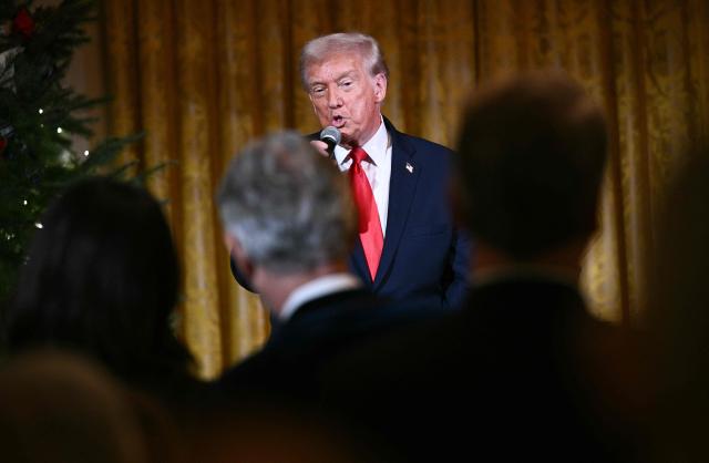 US President Donald Trump delivers remarks before attending a concert by Italian tenor Andrea Bocelli in the East Room of the White House in Washington, DC on December 5, 2025. (Photo by Brendan SMIALOWSKI / AFP)