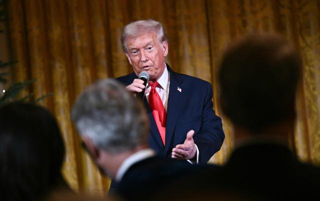 US President Donald Trump delivers remarks before attending a concert by Italian tenor Andrea Bocelli in the East Room of the White House in Washington, DC on December 5, 2025. (Photo by Brendan SMIALOWSKI / AFP)