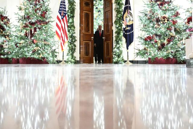 US President Donald Trump arrives in the East Room of the White House to attend a concert by Italian tenor Andrea Bocelli in Washington, DC on December 5, 2025. (Photo by Brendan SMIALOWSKI / AFP)