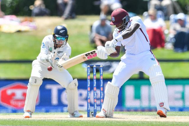 West Indies' Justin Greaves plays a shot in front of New Zealand's wicketkeeper Tom Latham during day five of the first Test cricket match between New Zealand and West Indies at Hagley Oval in Christchurch on December 6, 2025. (Photo by Sanka Vidanagama / AFP)