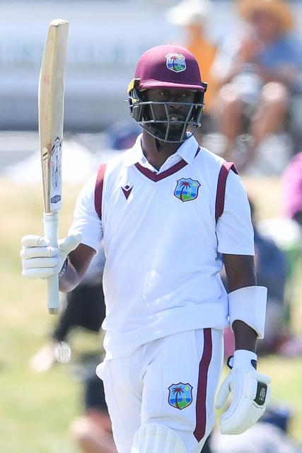 West Indies' Kemar Roach celebrates his half century during day five of the first Test cricket match between New Zealand and West Indies at Hagley Oval in Christchurch on December 6, 2025. (Photo by Sanka Vidanagama / AFP)