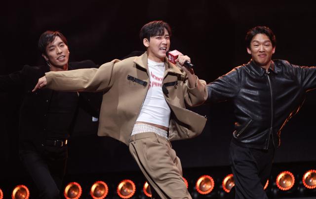 US singer Kevin Woo (C) performs on stage during the KIIS FM's iHeartRadio Jingle Ball 2025 at the Inuit Dome in Inglewood, California on December 4, 2025. (Photo by Michael Tran / AFP)