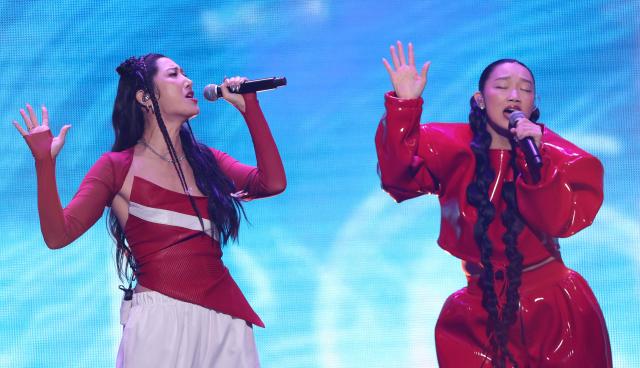 (L-R) Singers Ejae and Audrey Nuna from the band HUNTR/X perform on stage during the KIIS FM's iHeartRadio Jingle Ball 2025 at the Inuit Dome in Inglewood, California on December 4, 2025. (Photo by Michael Tran / AFP)