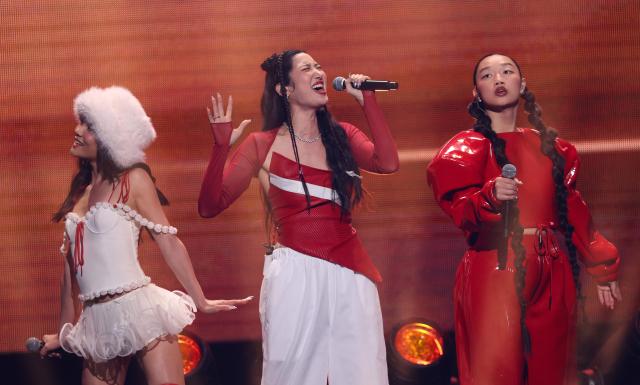 (L-R) Singers Rei Ami, Ejae and Audrey Nuna from the band HUNTR/X perform on stage during the KIIS FM's iHeartRadio Jingle Ball 2025 at the Inuit Dome in Inglewood, California on December 4, 2025. (Photo by Michael Tran / AFP)