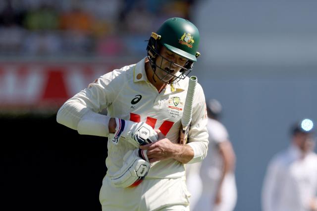 Australia’s Alex Carey reacts as he walks off the ground after being dismissed on day three of the second Ashes cricket Test match between Australia and England at The Gabba in Brisbane on December 6, 2025. (Photo by DAVID GRAY / AFP)