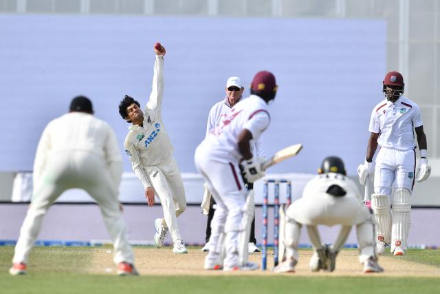 New Zealand's Rachin Ravindra bowls during day five of the first Test cricket match between New Zealand and West Indies at Hagley Oval in Christchurch on December 6, 2025. (Photo by Sanka Vidanagama / AFP)