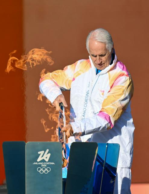 President of the Milano Cortina 2026 Organizing Committee Giovanni Malago lights the torch at the Stadio dei Marmi (Stadium of the Marbles) one of four stadiums located in the Foro Italico sports complex during the Torch Relay to Milano Cortina 2026 Olympic Games, in Rome on December 6, 2025. (Photo by Alberto PIZZOLI / AFP)