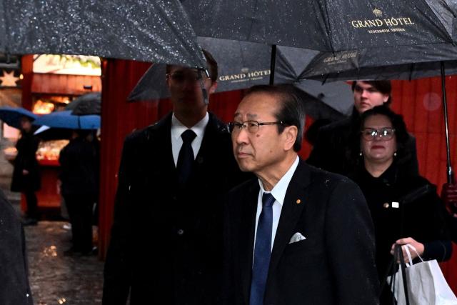 Japanese Nobel Prize-winning chemist Susumu Kitagawa (C) arrives along with other Nobel laureates to sign the Nobel Chairs at the Nobel Museum in Stockholm on December 6, 2025. (Photo by Claudio BRESCIANI / TT News Agency / AFP) / Sweden OUT